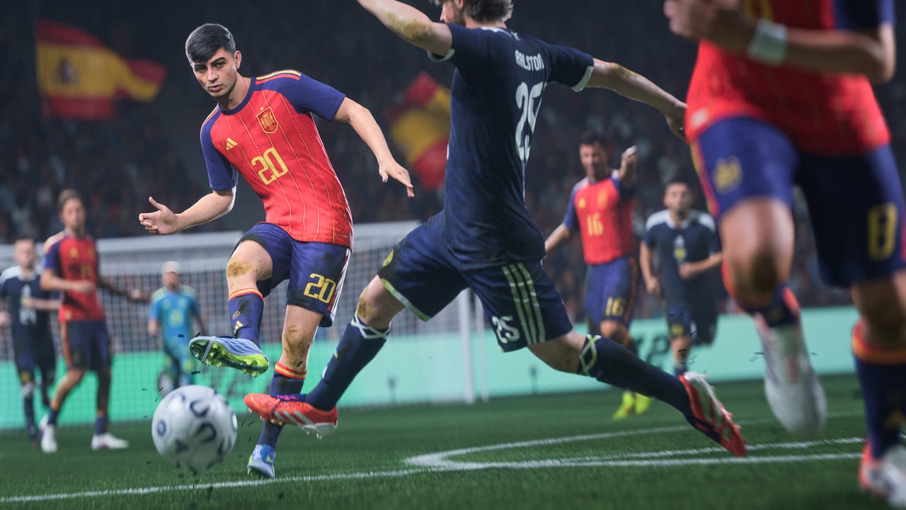 EA SPORTS FC 27 match action: Spain in red dribbles past a navy defender in a packed stadium.